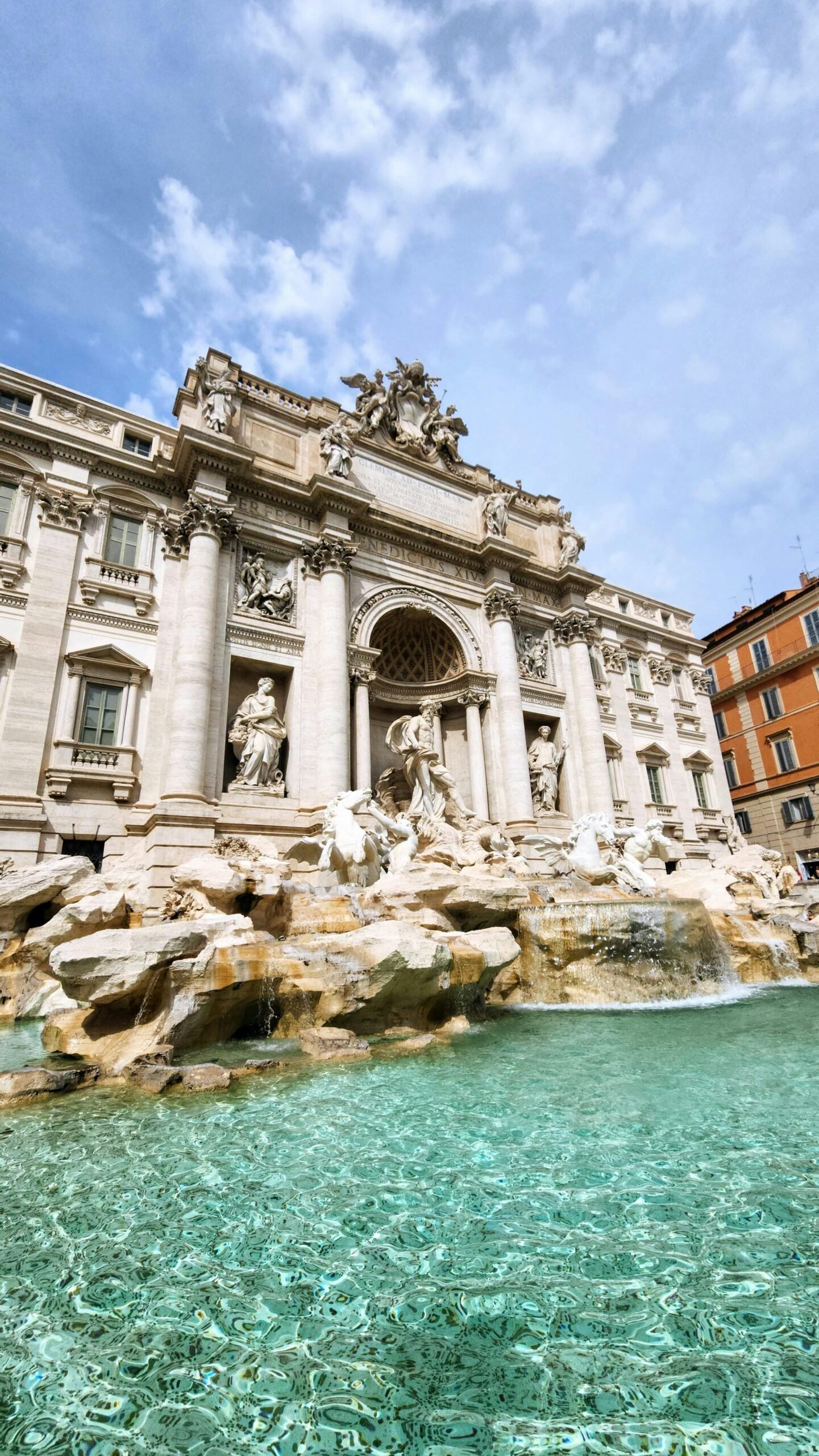 Low angle view of the famous Trevi Fountain in Rome, showcasing its magnificent architecture and vibrant waters.
