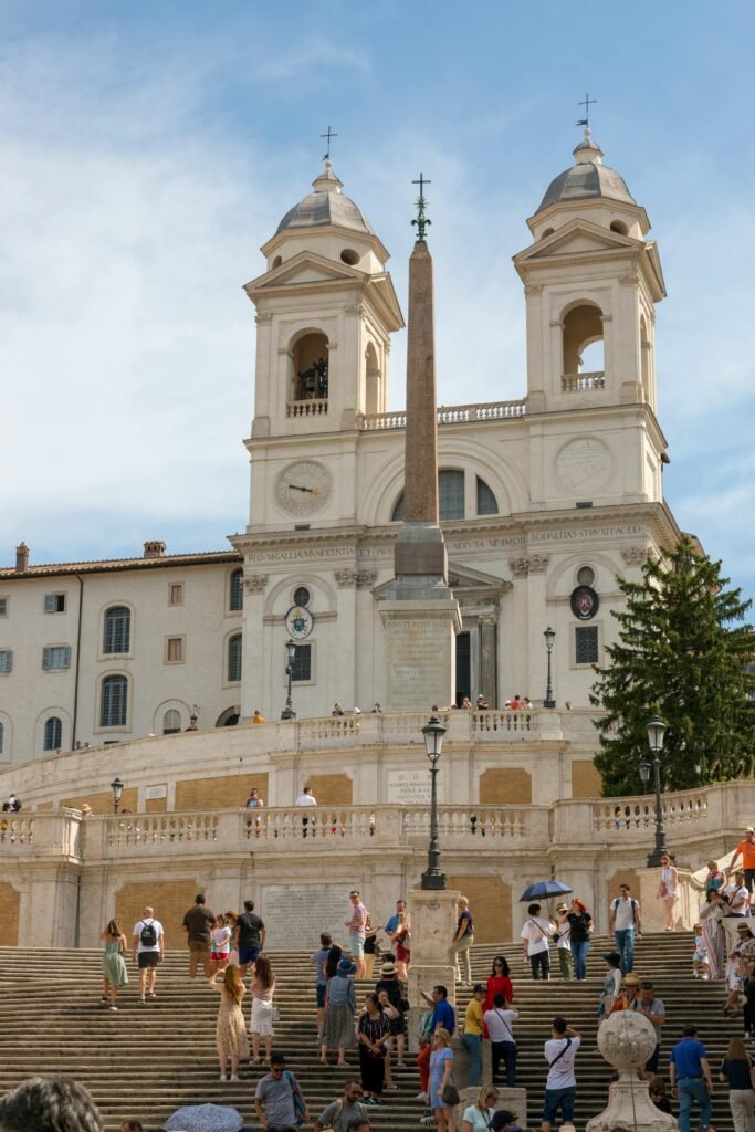 Crowded scene at the iconic Spanish Steps in Rome with tourists exploring.