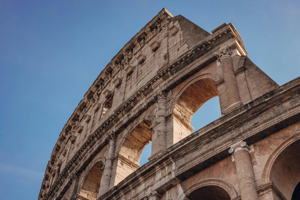 Stunning angled view of the Colosseum in Rome under a clear blue sky.