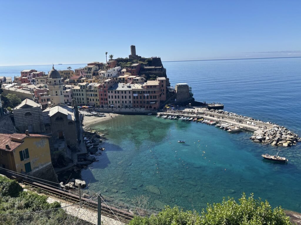 Cinque Terre Photoshoot & Proposal Guide: Manarola, Vernazza, Riomaggiore Vernazza harbour and Doria castle tower from the coastal trail, Cinque Terre