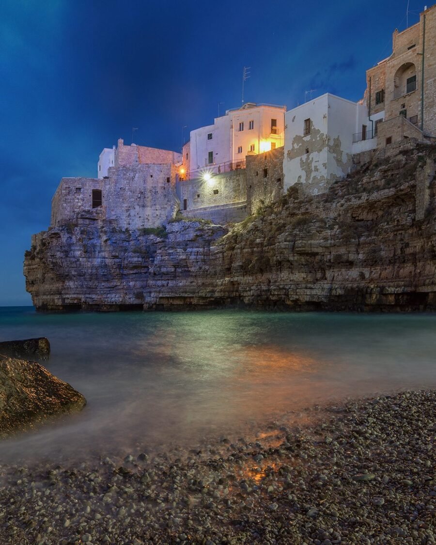 Lama Monachile cove and the old town of Polignano a Mare at blue hour