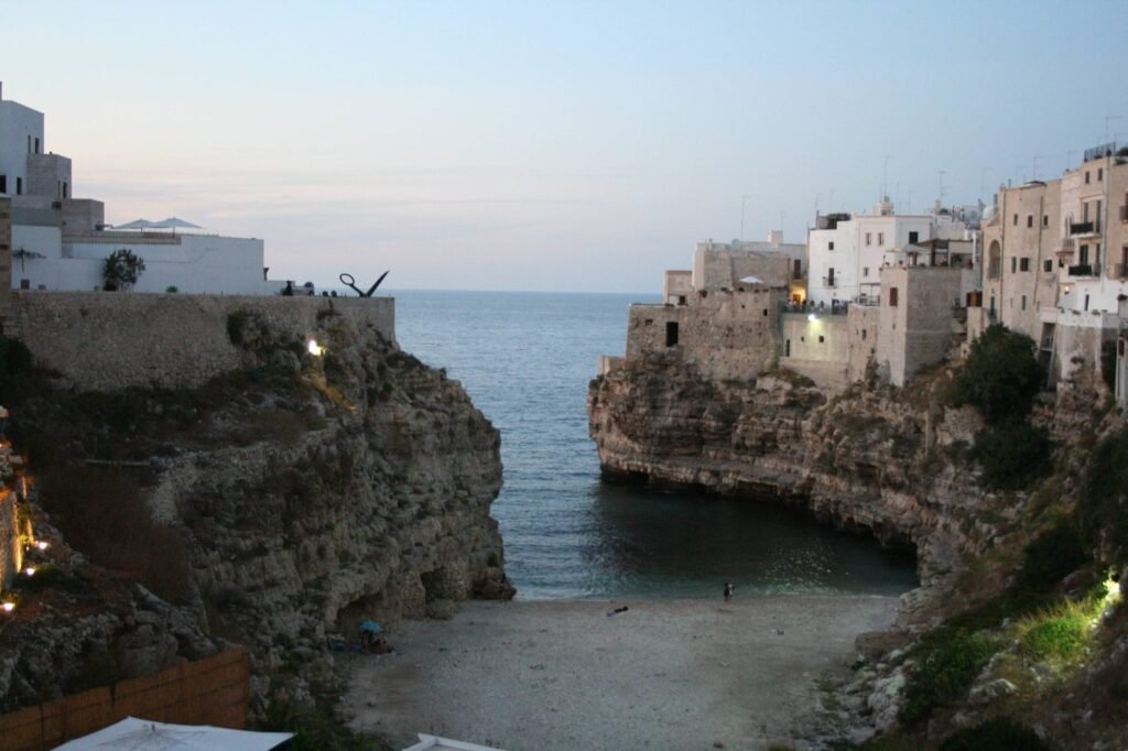 Polignano a Mare cliffs and Lama Monachile beach in evening light
