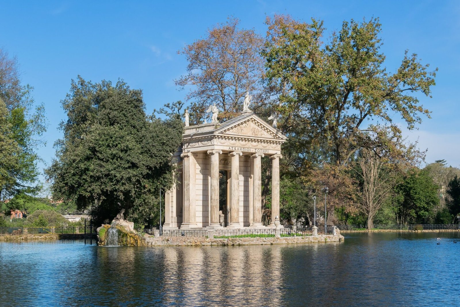 Villas in Rome for Photoshoots & Weddings: 11 Historic Estates (and How to Book Them) The Temple of Aesculapius on the lake of Villa Borghese in Rome, reflected in still water