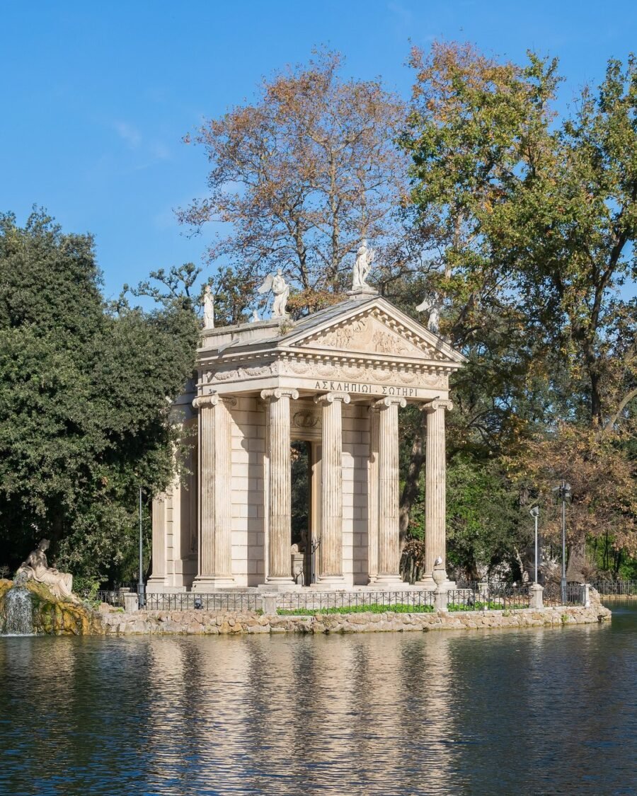 The Temple of Aesculapius on the lake of Villa Borghese in Rome, reflected in still water
