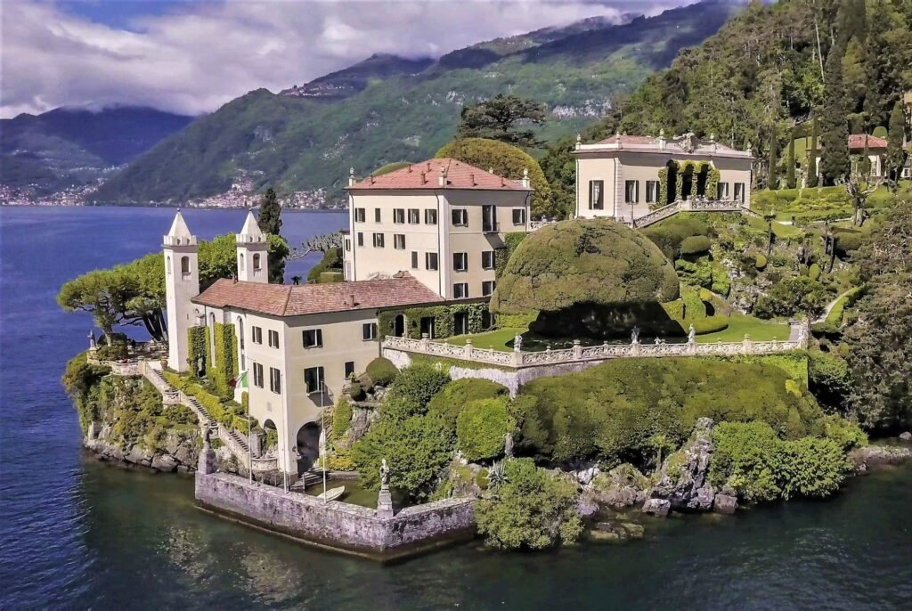 Lake Como Villas for Weddings & Photoshoots: Balbianello, Carlotta, Villa d’Este and More Aerial view of Villa del Balbianello on its wooded promontory at Lenno on Lake Como