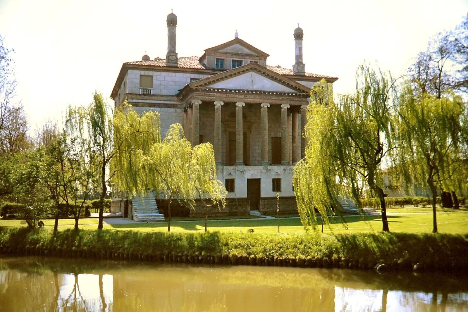 Palladio’s Villa Foscari “La Malcontenta” reflected in the Brenta canal between willows